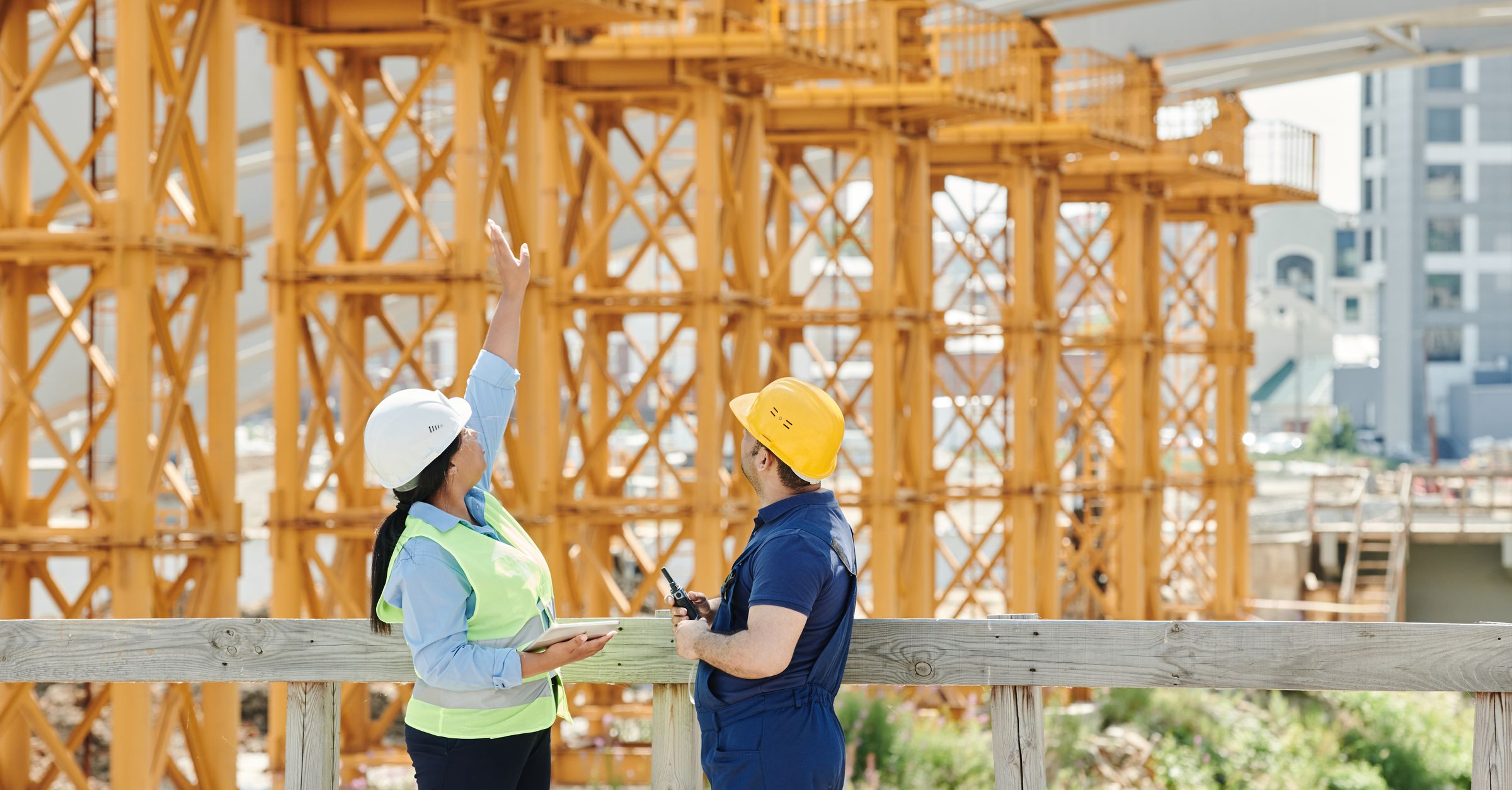 Construction site supervisor using a tablet for photo AI ticket review